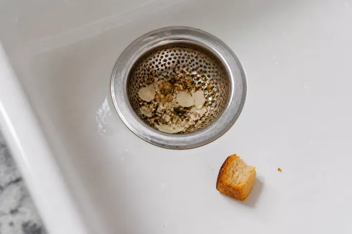 Herbs, crumbs and parmesan caught beside a larger crouton